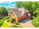 Stately two-story brick home with an attached three-car garage and lush landscaping at 2111 Broadfield Run, Duluth, GA 30097