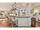 Kitchen featuring a breakfast bar with seating, granite countertops, and modern appliances at 2111 Broadfield Run, Duluth, GA 30097