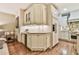 An open-concept kitchen features an island with a wine fridge at 2111 Broadfield Run, Duluth, GA 30097