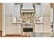 Gourmet kitchen featuring granite countertops, a stainless steel range, and tile backsplash at 2111 Broadfield Run, Duluth, GA 30097