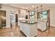 Bright kitchen features an island, recessed lighting, and hardwood floors at 2111 Broadfield Run, Duluth, GA 30097