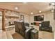 A comfortable living room with plush leather recliners and a stone fireplace offers a cozy retreat at 2111 Broadfield Run, Duluth, GA 30097