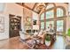 Bright living room with vaulted ceiling, exposed beams, stone fireplace, and large windows at 2111 Broadfield Run, Duluth, GA 30097