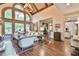 Beautiful living room with hardwood floors and arched windows, seamlessly connected to the kitchen at 2111 Broadfield Run, Duluth, GA 30097
