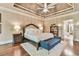 A spacious main bedroom featuring a tray ceiling, king bed, and hardwood floors at 2111 Broadfield Run, Duluth, GA 30097
