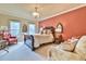 A spacious main bedroom featuring two chairs, a king bed, and large windows at 2111 Broadfield Run, Duluth, GA 30097