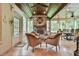 Relaxing sunroom with a stone fireplace, hardwood ceiling, and lots of light at 2111 Broadfield Run, Duluth, GA 30097