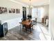 Bright dining room with hardwood floors, modern light fixture, and decorative wall paintings at 275 Creek View Pl, Canton, GA 30114