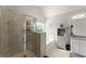 Well-lit bathroom featuring a glass shower, soaking tub, storage cabinet, and a granite-topped vanity at 275 Creek View Place, Canton, GA 30114
