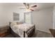 Bedroom featuring a metal bed frame, neutral bedding, and a side table at 275 Creek View Place, Canton, GA 30114
