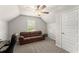 Bright room featuring a cozy brown couch and a ceiling fan at 275 Creek View Place, Canton, GA 30114