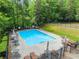 Community pool with lounge chairs and lush greenery surrounding the area at 275 Creek View Place, Canton, GA 30114