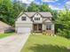 Charming two-story home featuring a well-manicured lawn, attached two car garage, and beautiful front yard landscaping at 275 Creek View Place, Canton, GA 30114