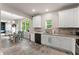 Bright kitchen with stainless steel appliances, white cabinets, and a dining area at 275 Creek View Place, Canton, GA 30114