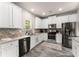 Well-lit kitchen featuring stainless steel appliances, granite countertops, and white cabinetry at 275 Creek View Place, Canton, GA 30114