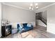 Comfortable living room with a blue sofa and staircase at 275 Creek View Place, Canton, GA 30114