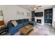 Open-concept living room with a cozy sectional, fireplace, and built-in shelves at 275 Creek View Place, Canton, GA 30114
