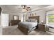 Large main bedroom features a tray ceiling, carpeting, lots of light, and a king-size bed at 275 Creek View Place, Canton, GA 30114
