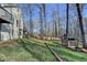 View of the backyard featuring a wooden border, tall trees, and a playhouse at 3075 Superior Dr, Dacula, GA 30019