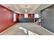 Finished basement with neutral carpet, recessed lights and half-painted accent wall at 3075 Superior Dr, Dacula, GA 30019