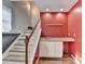 Basement wet bar with white cabinets and sink adjacent to carpeted staircase at 3075 Superior Dr, Dacula, GA 30019