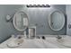 Well-lit bathroom with double sinks, large vanity mirror at 3075 Superior Dr, Dacula, GA 30019
