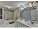 Bright bathroom with dual sink vanity, large mirror, and shower with sliding glass door at 3075 Superior Dr, Dacula, GA 30019