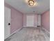 Inviting bedroom with soft pink walls and neutral carpet, providing a cozy and relaxing retreat at 3075 Superior Dr, Dacula, GA 30019