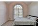Cozy bedroom featuring a large arched window providing ample natural light and neutral colored walls at 3075 Superior Dr, Dacula, GA 30019