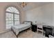 Cozy bedroom featuring a large arched window providing ample natural light, plus desk area at 3075 Superior Dr, Dacula, GA 30019