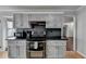 Kitchen with painted cabinets, dark countertops, and stainless steel appliances at 3075 Superior Dr, Dacula, GA 30019