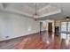 Expansive living room with hardwood flooring, tray ceiling with chandelier, and neutral color palette at 3075 Superior Dr, Dacula, GA 30019