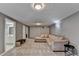 Spacious living room features plush carpet and a large sectional sofa, perfect for relaxing and entertaining guests at 3075 Superior Dr, Dacula, GA 30019