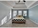 Relaxing main bedroom with blue walls, carpet, and tray ceiling at 3075 Superior Dr, Dacula, GA 30019