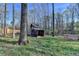 A shed in the backyard surrounded by mature trees at 3075 Superior Dr, Dacula, GA 30019