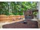 Fenced backyard with fire pit and multiple levels including a deck with a small table and chairs at 3962 Coventry Park Ln, Peachtree Corners, GA 30096