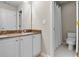 Well lit bathroom featuring dual sinks, white cabinets, and a white toilet and shower at 3962 Coventry Park Ln, Peachtree Corners, GA 30096
