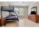 Bright bedroom with bunk beds, dresser, and pale wood floors, perfect for ! at 3962 Coventry Park Ln, Peachtree Corners, GA 30096