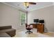 Study or bedroom area with hardwood floors, desk and rolling chair, and view to outside at 3962 Coventry Park Ln, Peachtree Corners, GA 30096