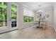 Bright dining area with backyard views, featuring hardwood floors and a modern chandelier at 3962 Coventry Park Ln, Peachtree Corners, GA 30096