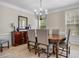 Elegant dining room featuring a modern chandelier and a dark wood table with upholstered chairs at 3962 Coventry Park Ln, Peachtree Corners, GA 30096