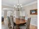 Spacious dining room with hardwood floors, complemented by a modern chandelier and archway at 3962 Coventry Park Ln, Peachtree Corners, GA 30096