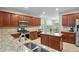 Modern kitchen featuring granite countertops, stainless steel appliances, and wooden cabinets at 3962 Coventry Park Ln, Peachtree Corners, GA 30096