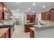 Bright eat-in kitchen featuring stainless steel appliances, granite countertops, and wooden cabinetry at 3962 Coventry Park Ln, Peachtree Corners, GA 30096