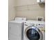 Laundry room featuring modern dryer and washer, as well as wire shelving unit at 3962 Coventry Park Ln, Peachtree Corners, GA 30096