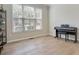 Bright office space with hardwood floors, featuring a window and an upright piano at 3962 Coventry Park Ln, Peachtree Corners, GA 30096