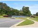 A community tennis court is surrounded by a black fence and beautiful trees at 3962 Coventry Park Ln, Peachtree Corners, GA 30096