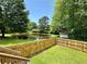 Fenced backyard with a pond offers privacy and a picturesque view, perfect for outdoor enjoyment at 485 Angham Rd, Hiram, GA 30141
