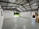 Spacious garage with high ceilings, concrete floors, and roll-up door offers ample space for storage and projects at 485 Angham Rd, Hiram, GA 30141