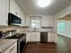 Bright kitchen featuring stainless steel appliances, white cabinets, granite countertops, and wood flooring at 485 Angham Rd, Hiram, GA 30141